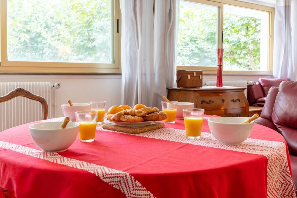 Breakfast on the table with a tablecloth in the living room at home, healthy breakfast with juices