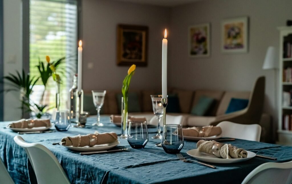 Tablescape. Table with tablecloth and candles served for lunch or dinner in the house.